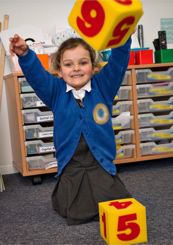 girl playing with number dice