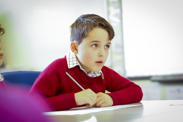 Boy writing in class