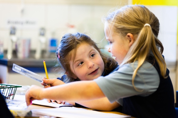 Girls writing in class